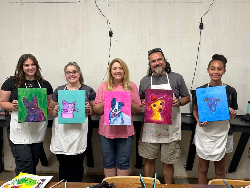 a group of people with their finished art projects