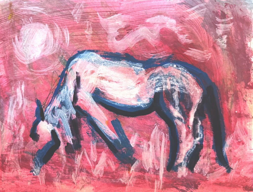 a white horse grazes in a pink field