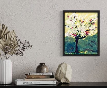 Cherry Blossom painting in a living room above a table with books.