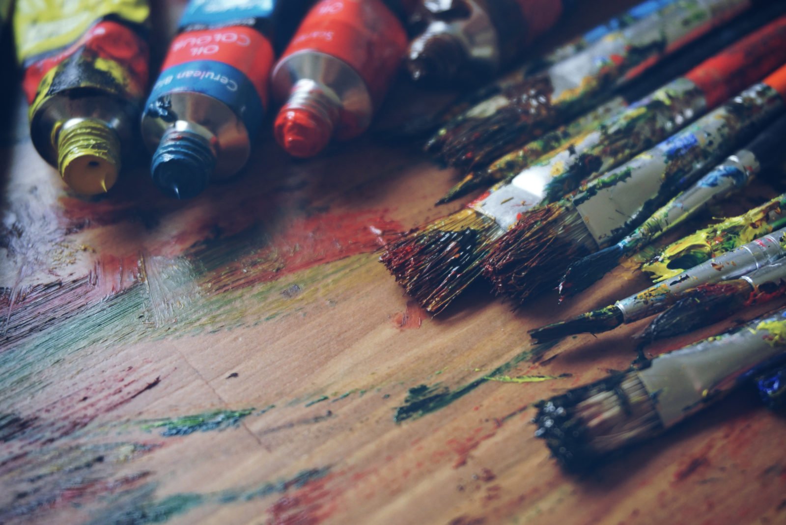 brushes and paint on a wooden table